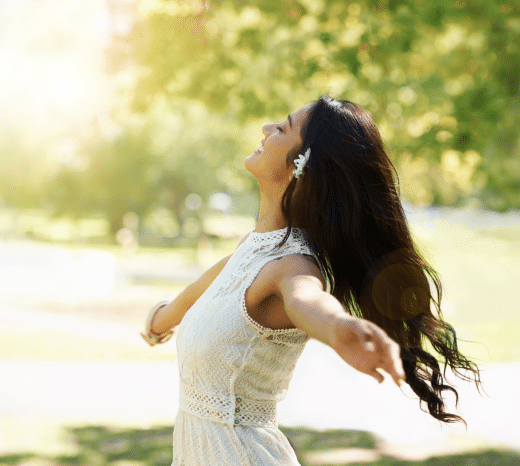 Woman enjoying sunshine in a green park