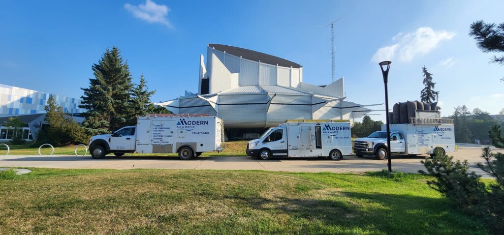 Modern Air and Water service trucks parked outside edmonton space and science centre
